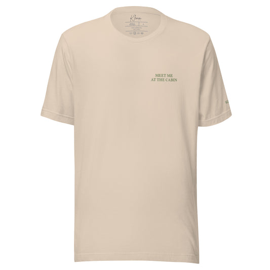 Soft cream Meet Me at the Cabin graphic T-shirt by Klemm & Co., front view with subtle green chest text.