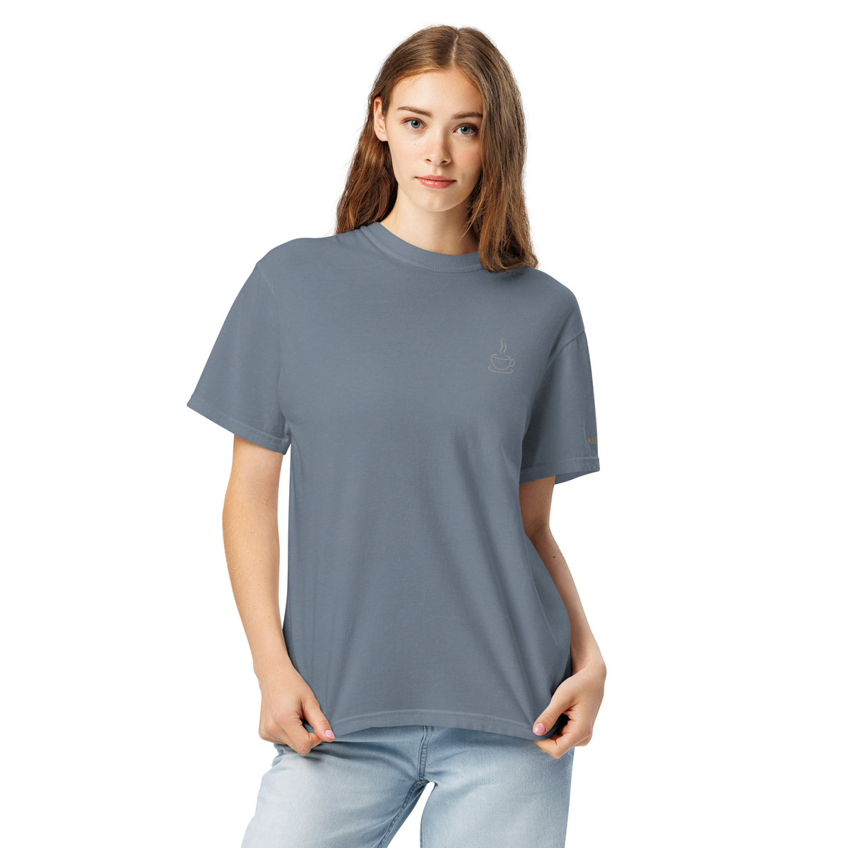 Female model wearing the blue jean Poured for This coffee T-shirt by Klemm & Co., front view showing the coffee cup design embroidered in grey thread.