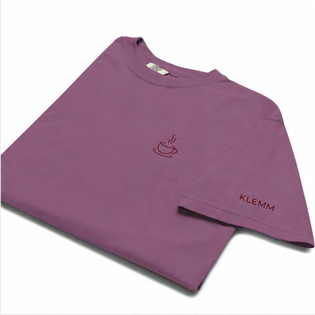 Folded berry Poured for This coffee T-shirt by Klemm & Co., showing the embroidered coffee cup design and KLEMM sleeve branding in maroon thread.