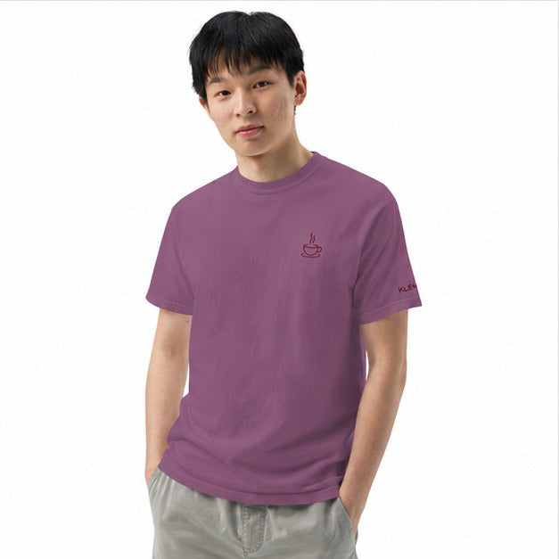 Male model wearing the berry Poured for This coffee T-shirt by Klemm & Co., front view showing the embroidered coffee cup design in maroon thread.