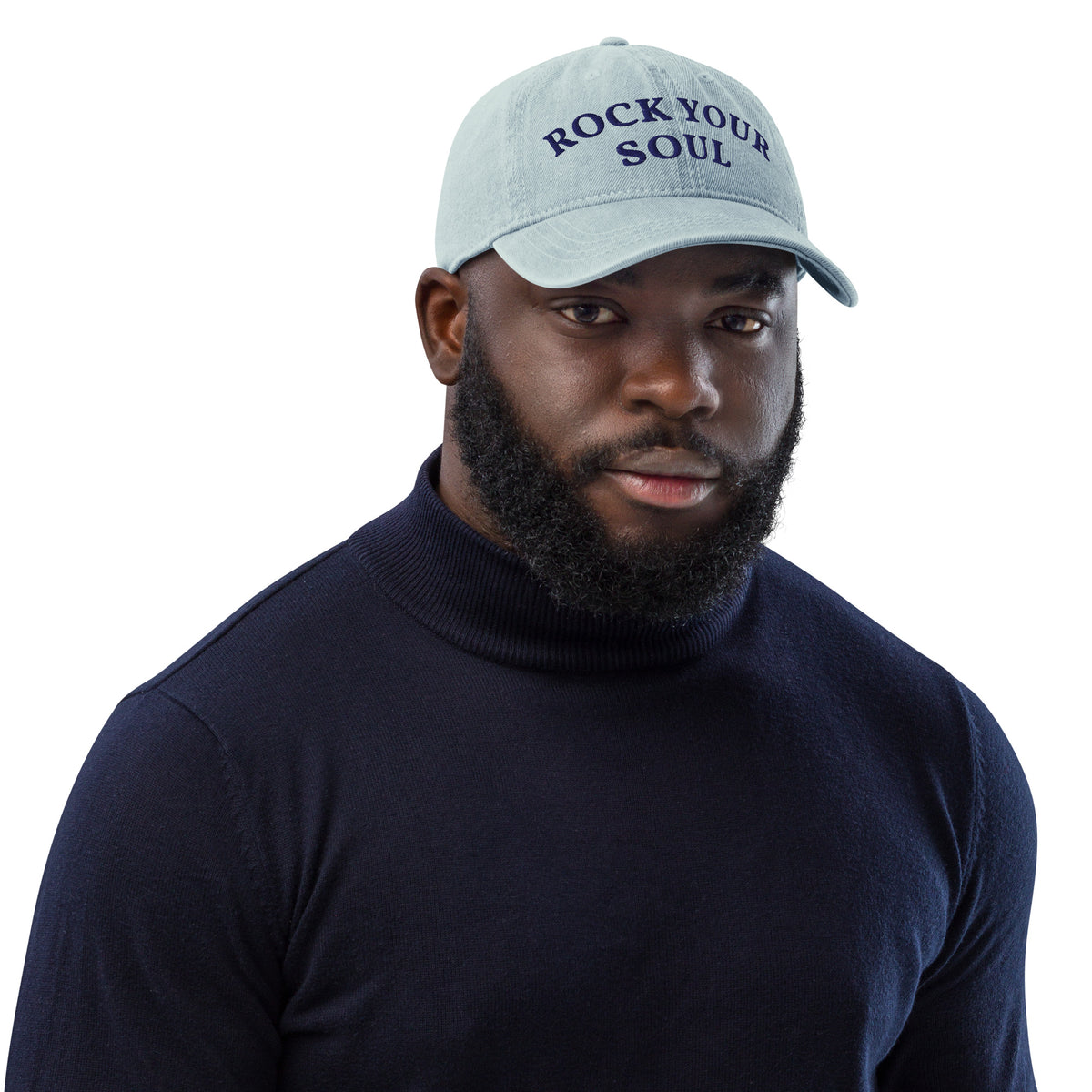 Male model wearing the light blue denim Rock Your Soul baseball hat by Klemm & Co., front view showing ROCK YOUR SOUL embroidered in navy thread.