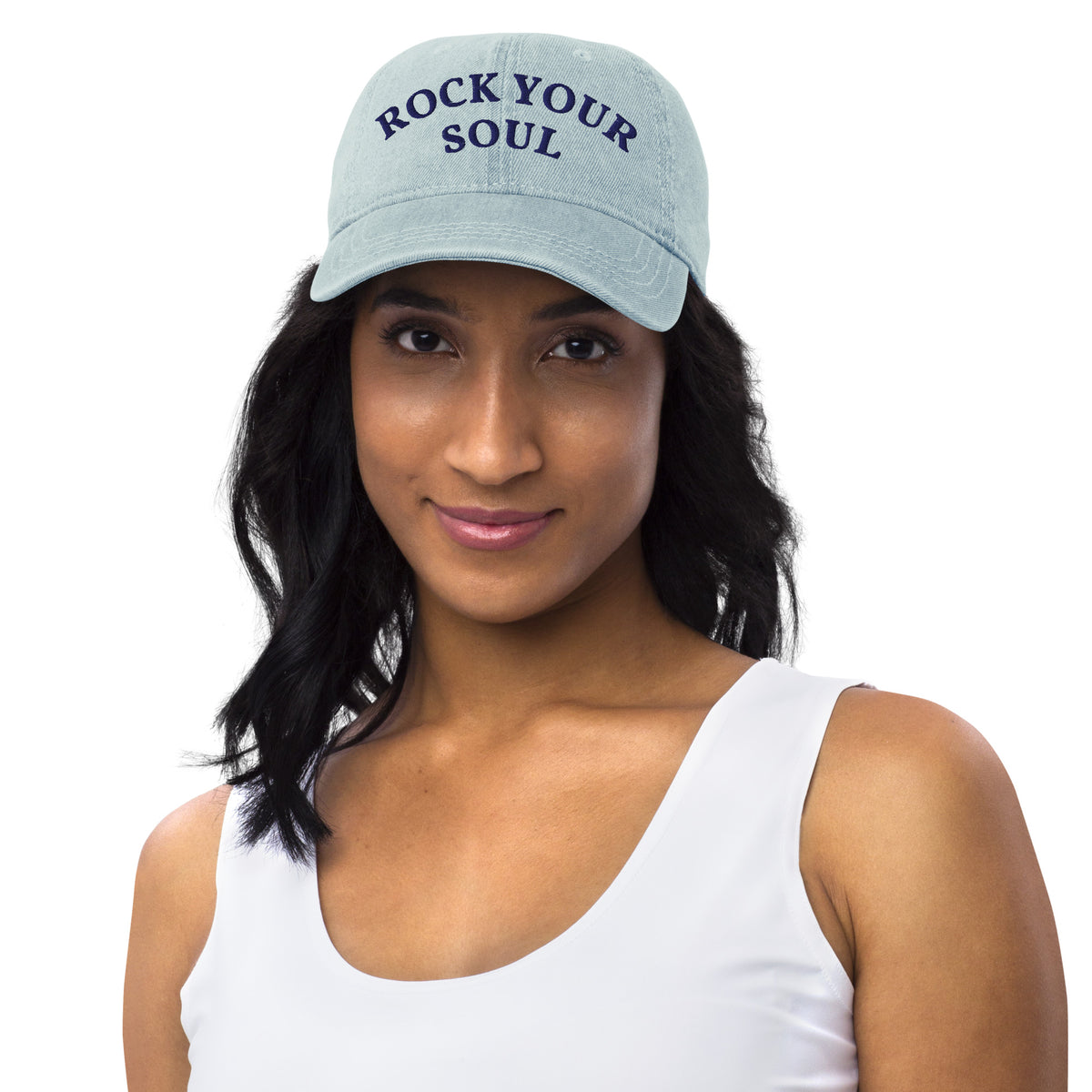 Female model wearing the light blue denim Rock Your Soul baseball hat by Klemm & Co., front view showing ROCK YOUR SOUL embroidered in navy thread.