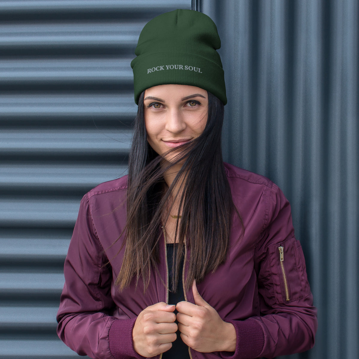 Female model wearing the dark green Rock Your Soul toque by Klemm & Co., front view showing ROCK YOUR SOUL embroidered in grey thread.