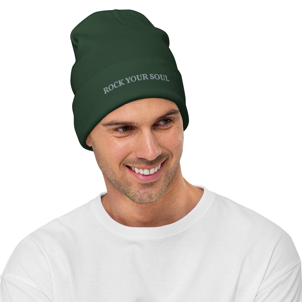 Male model wearing the dark green Rock Your Soul toque by Klemm & Co., front-left view showing ROCK YOUR SOUL embroidered in grey thread.