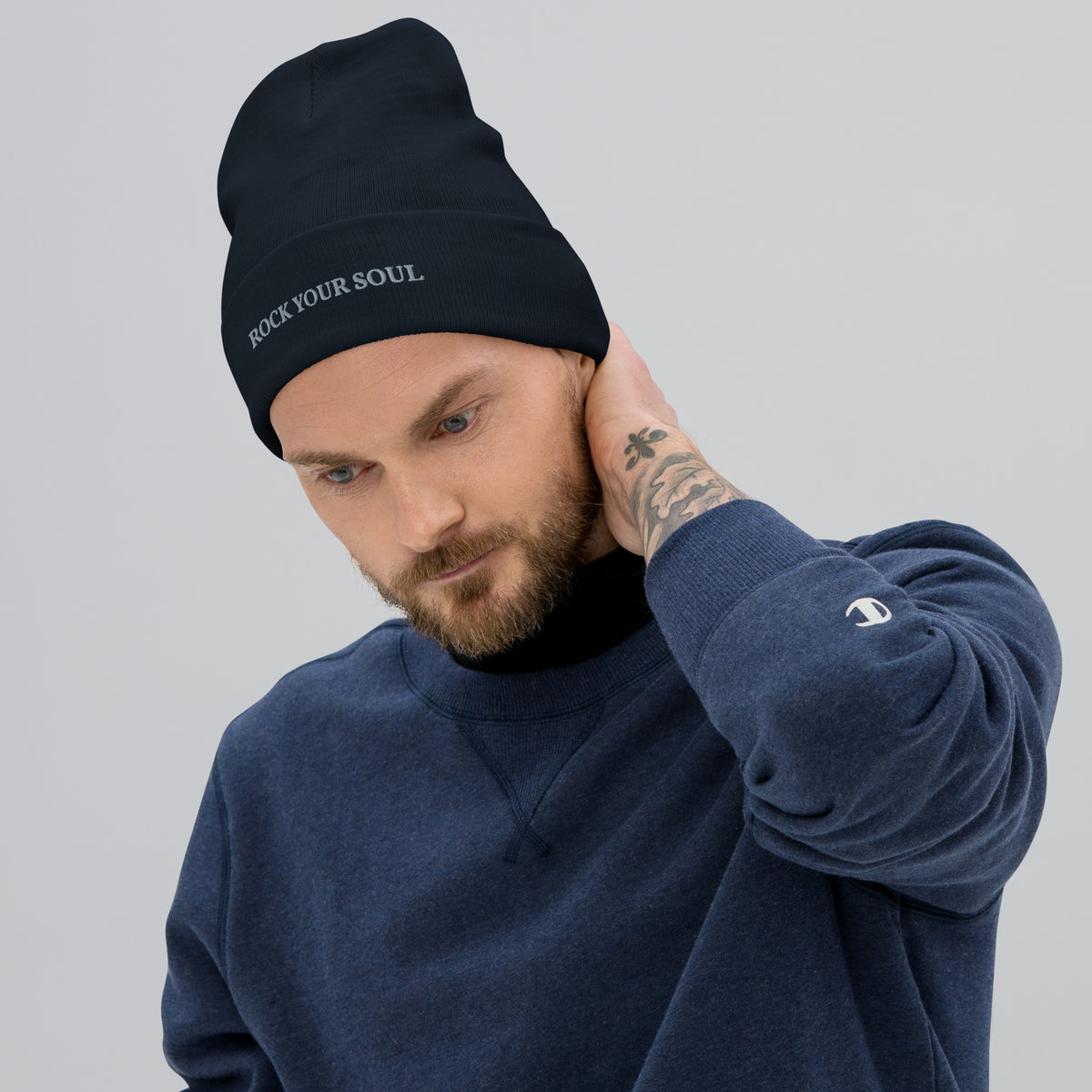 Male model wearing the navy Rock Your Soul toque by Klemm & Co., front-right view showing ROCK YOUR SOUL embroidered in grey thread.