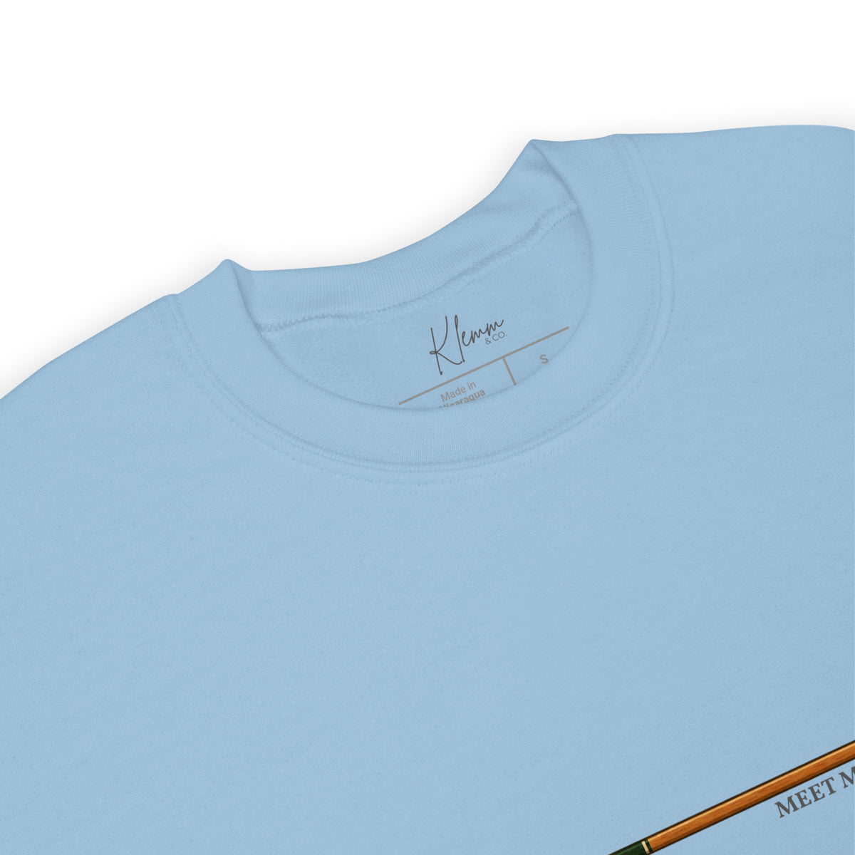 Close-up of the inside label on the light blue Meet Me at the Lake crewneck sweatshirt by Klemm & Co., showing the branded neck label.