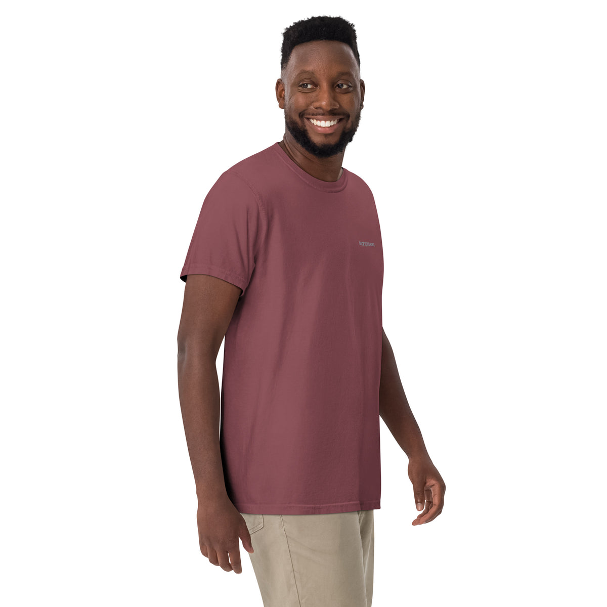 Male model wearing the brick Rock Your Soul T-shirt by Klemm & Co., front-right view showing ROCK YOUR SOUL embroidered in grey thread.