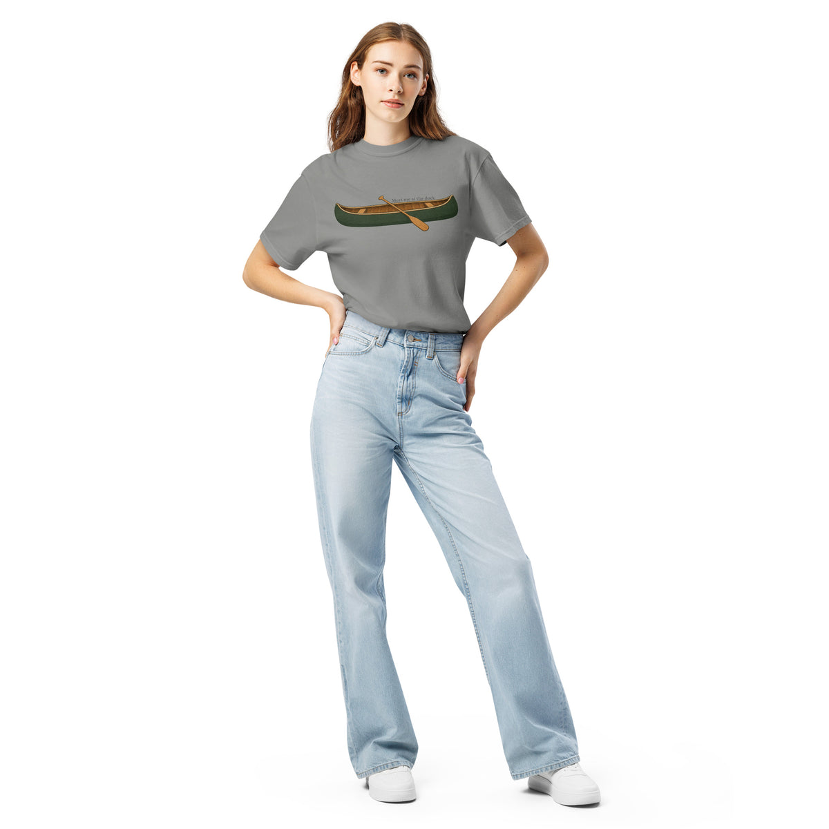 Female model wearing the grey Meet Me at the Dock graphic T-shirt by Klemm & Co., front view showing the printed canoe design.
