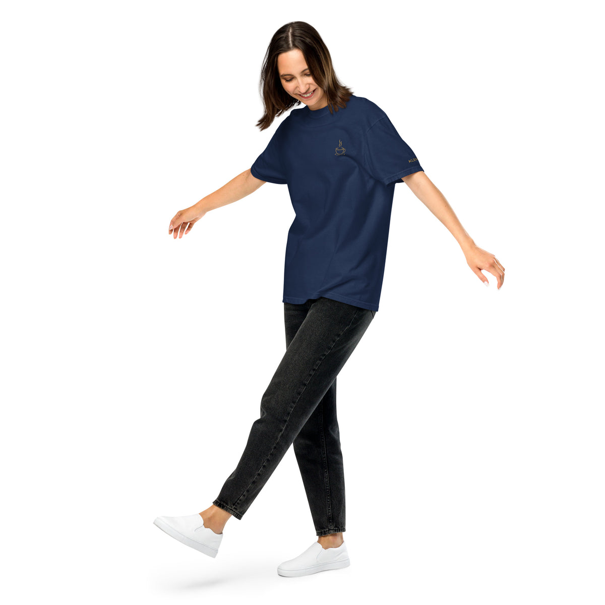 Female model wearing the navy Poured for This coffee T-shirt by Klemm & Co., front-left view showing the coffee cup design embroidered in gold thread.