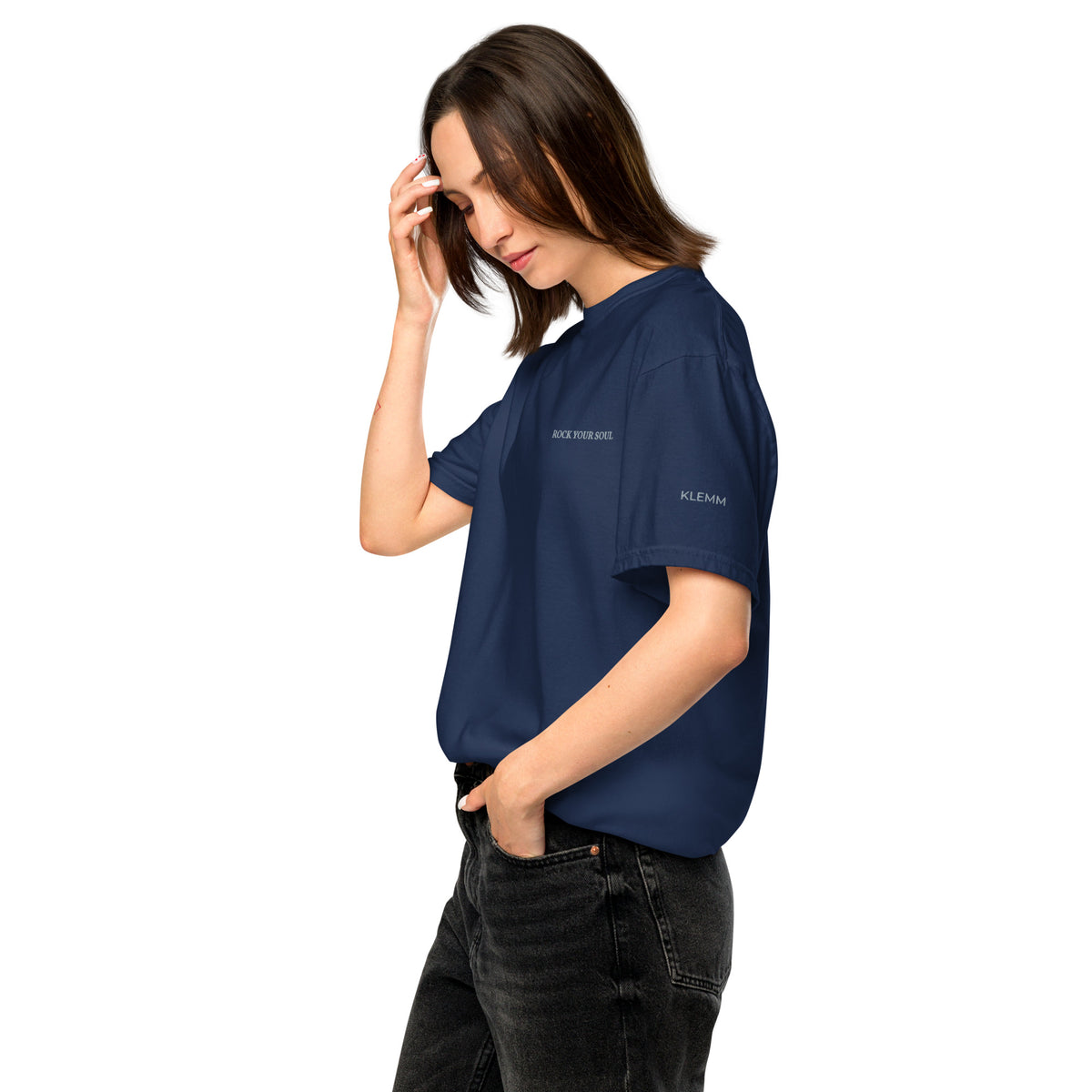 Female model wearing the navy Rock Your Soul T-shirt by Klemm & Co., left side view showing KLEMM embroidered in grey thread on the sleeve.