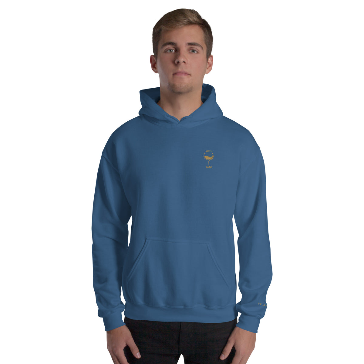 Male model wearing the indigo blue Poured for This wine hoodie by Klemm & Co., front view showing the gold embroidered wine glass design.
