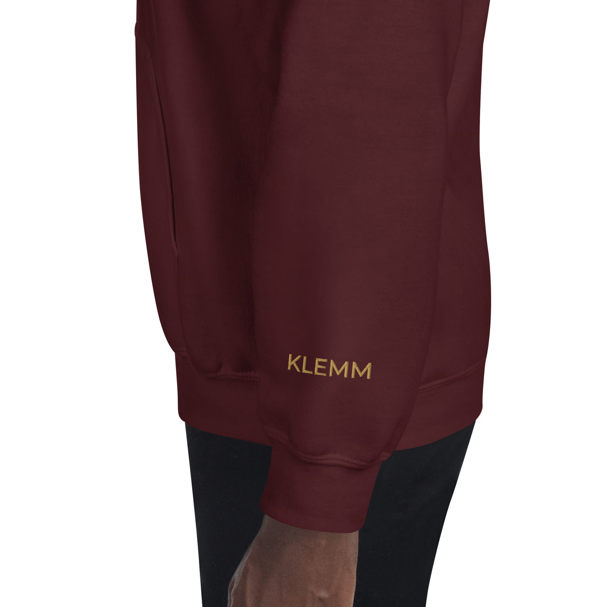 Side view of the maroon Poured for This wine hoodie by Klemm & Co., featuring KLEMM embroidered in gold thread on the sleeve.
