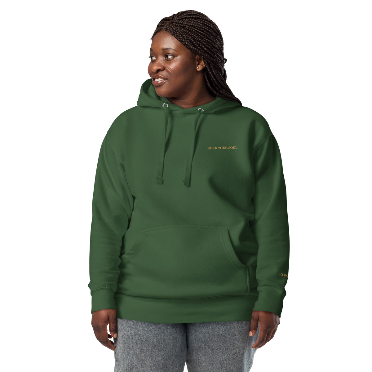 Female model wearing the forest green Rock Your Soul hoodie by Klemm & Co., front view showing ROCK YOUR SOUL embroidered in gold thread.